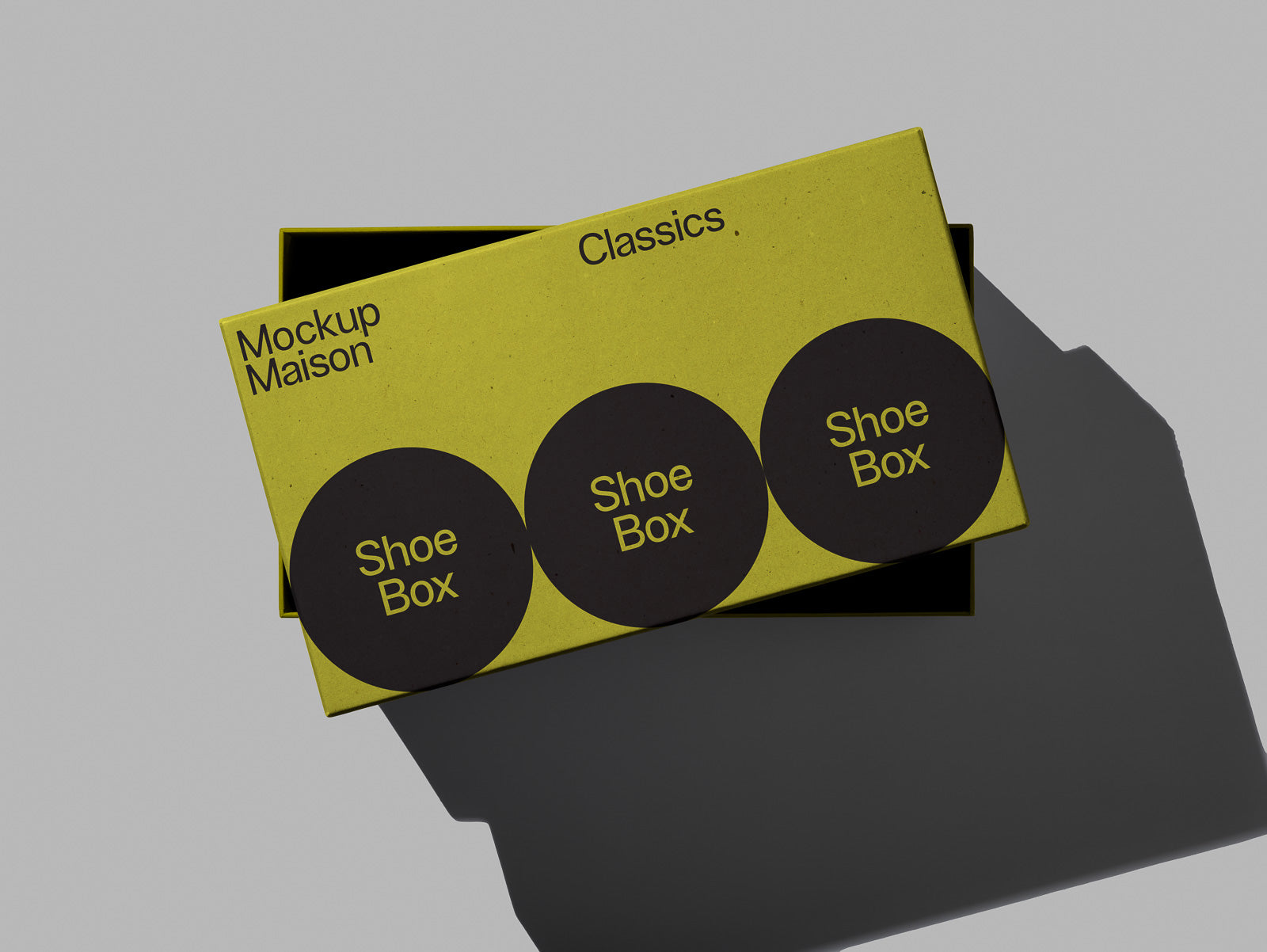 PSD mockup of a yellow shoe box from Mockup Maison labeled "Classics," featuring a lid with black circular designs and text reading "Shoe Box."