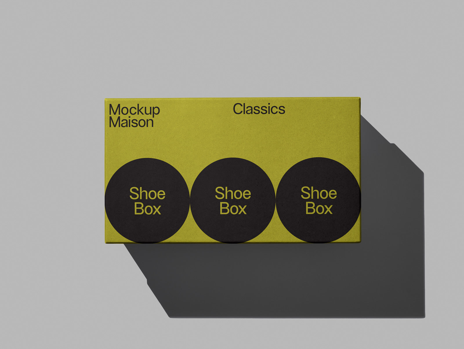 PSD mockup of a green shoebox with three black circles labeled "Shoe Box" on top, featuring the text "Mockup Maison Classics" on a gray background.
