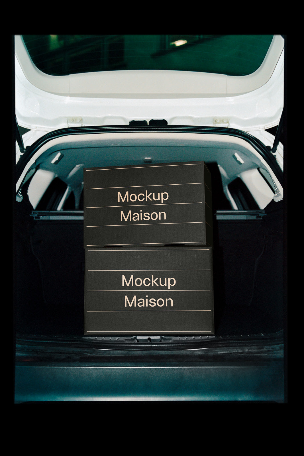 PSD mockup of two stacked black boxes with "Mockup Maison" text, placed in the open trunk of a white car.