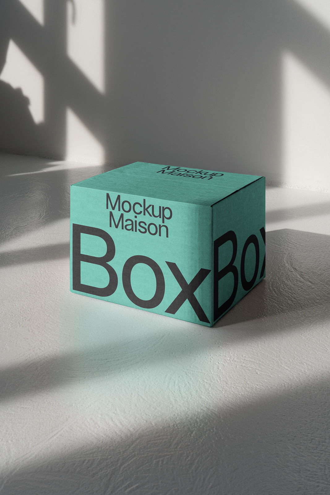 PSD mockup of a turquoise box labeled "Mockup Maison BoxBox," placed on a textured surface with soft shadows, highlighting its 3D structure.