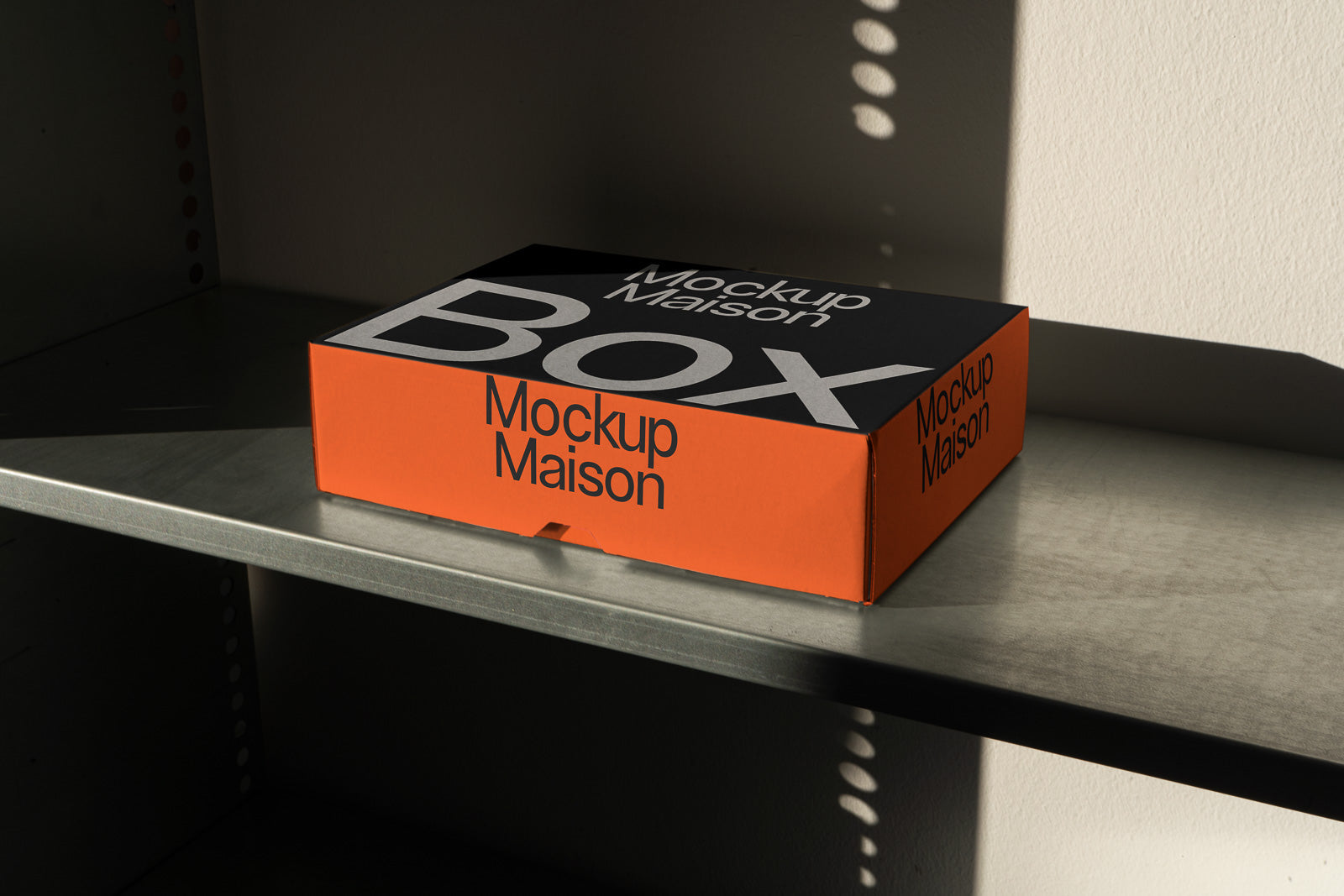 PSD mockup of an orange and black box labeled "Mockup Maison" placed on a metal shelf, showcasing shadow play and texture details.