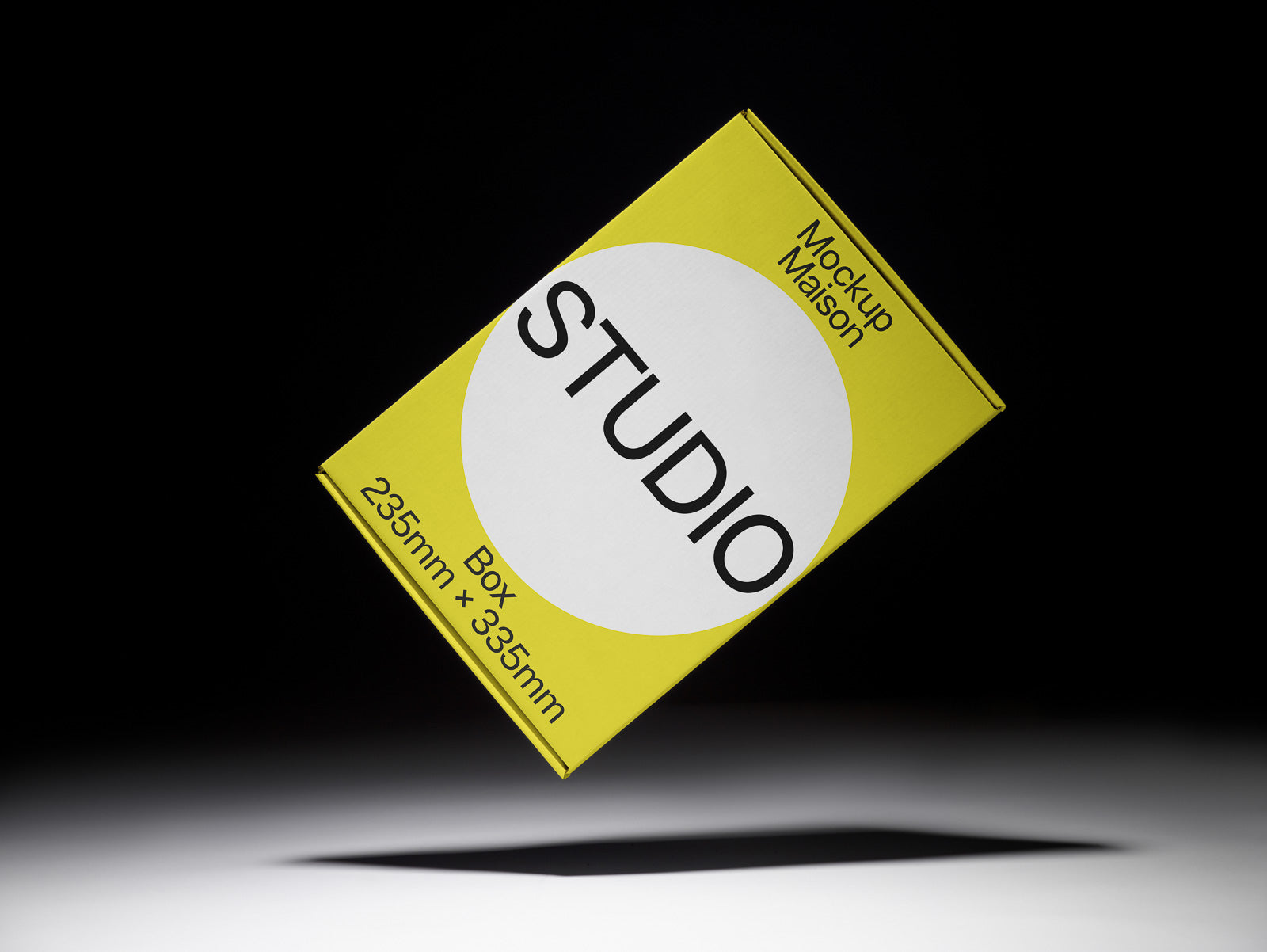 PSD mockup of a yellow and white box labeled "STUDIO" with dimensions 235mm x 335mm, floating against a dark background.