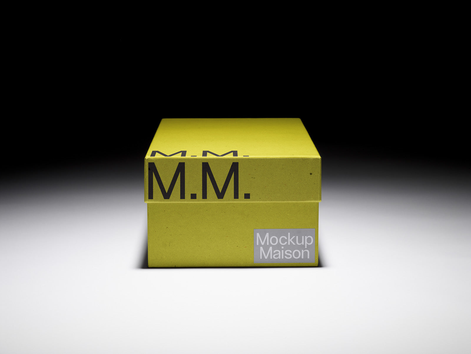 PSD mockup of a yellow rectangular box with the letters M.M. on the lid and side. The box is set against a gradient background, highlighting its design.