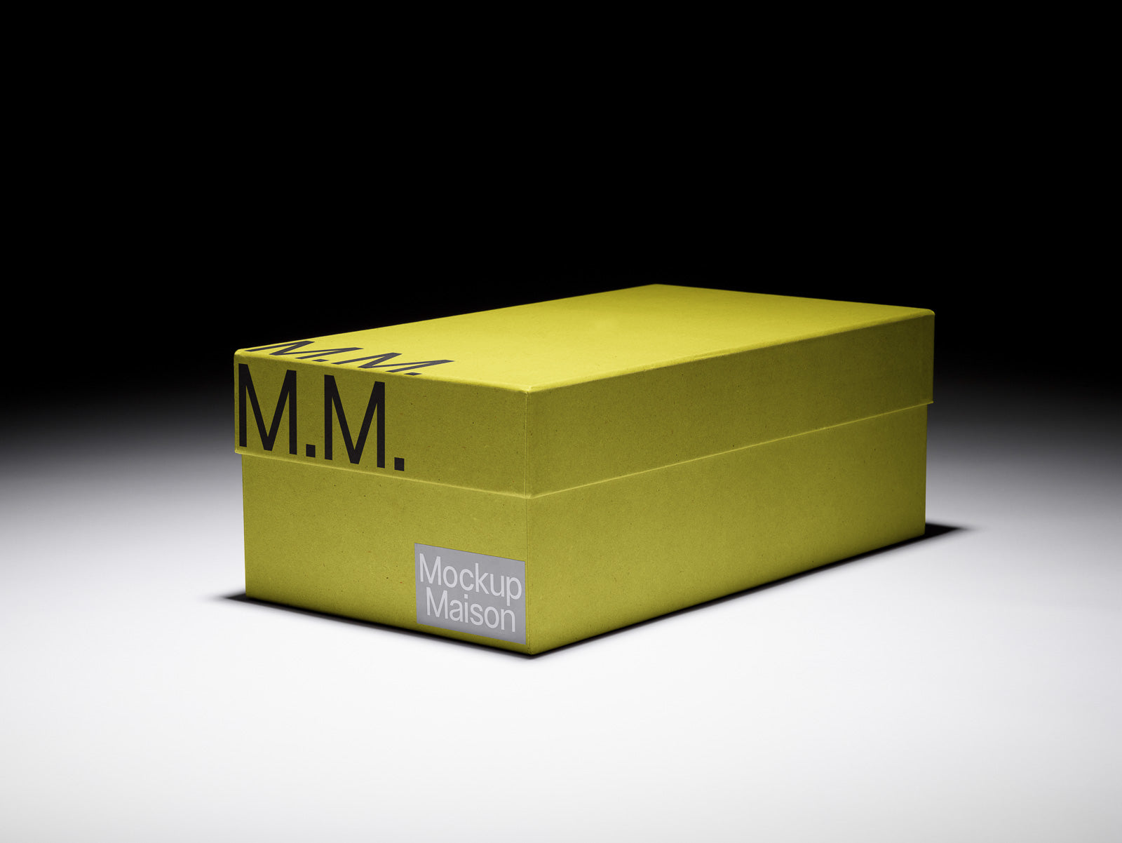 PSD mockup of a rectangular yellow box with "M.M." on top, labeled "Mockup Maison" on the side, against a shaded black background.