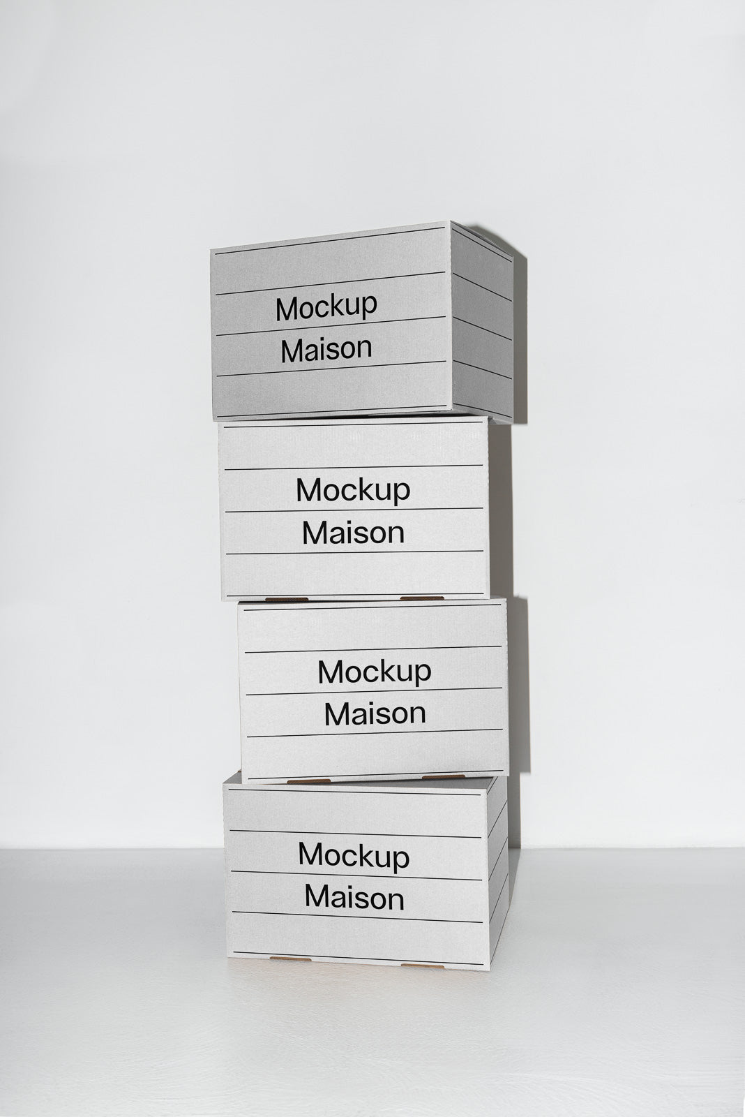 PSD mockup of stacked cardboard boxes labeled "Mockup Maison" against a plain background, showcasing packaging design.