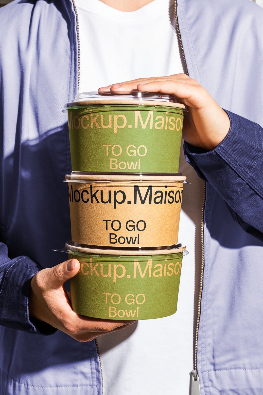 PSD mockup of a person holding three stacked eco-friendly to-go bowls labeled "Mockup.Maison" and "TO GO Bowl."
