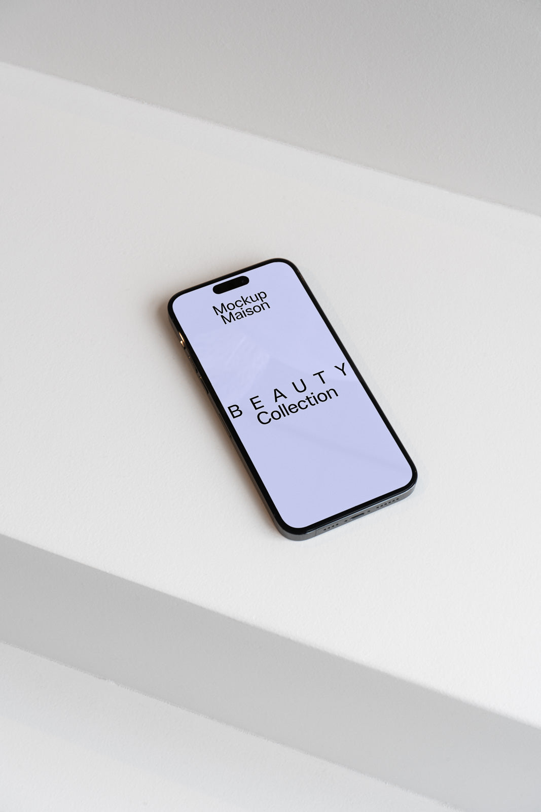 PSD mockup of a smartphone displaying "Beauty Collection" on a white surface, showcasing elegant minimalist design.