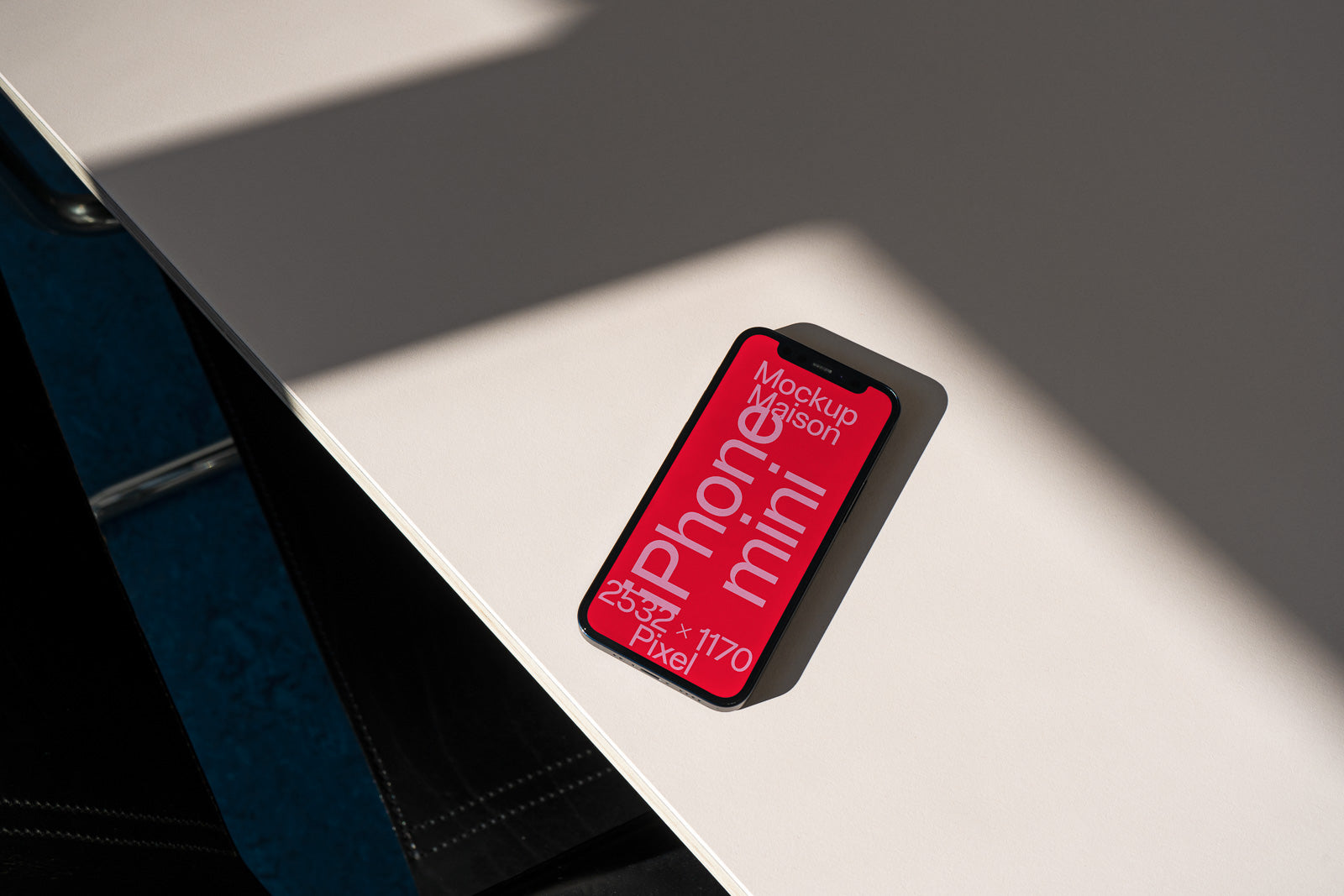 PSD mockup of a smartphone displaying a red screen with text, placed on a table casting a shadow from natural light.