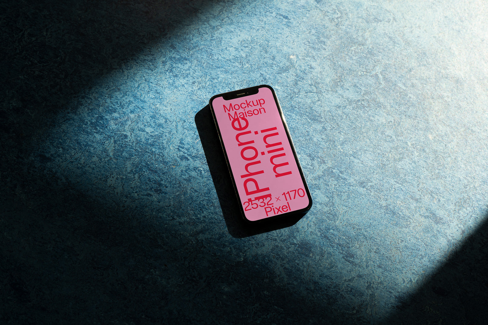 PSD mockup of a smartphone with a pink screen displaying text on a blue textured surface, partially illuminated by soft lighting.