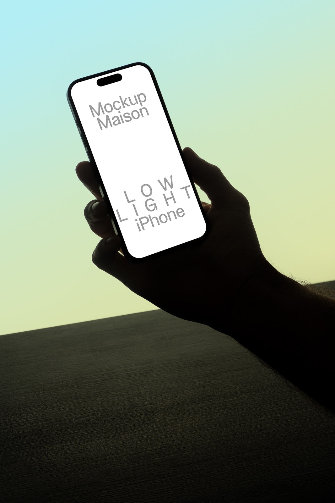 PSD mockup of a smartphone held against a gradient background, displaying the text "Mockup Maison" and "LOW LIGHT iPhone" on the screen.