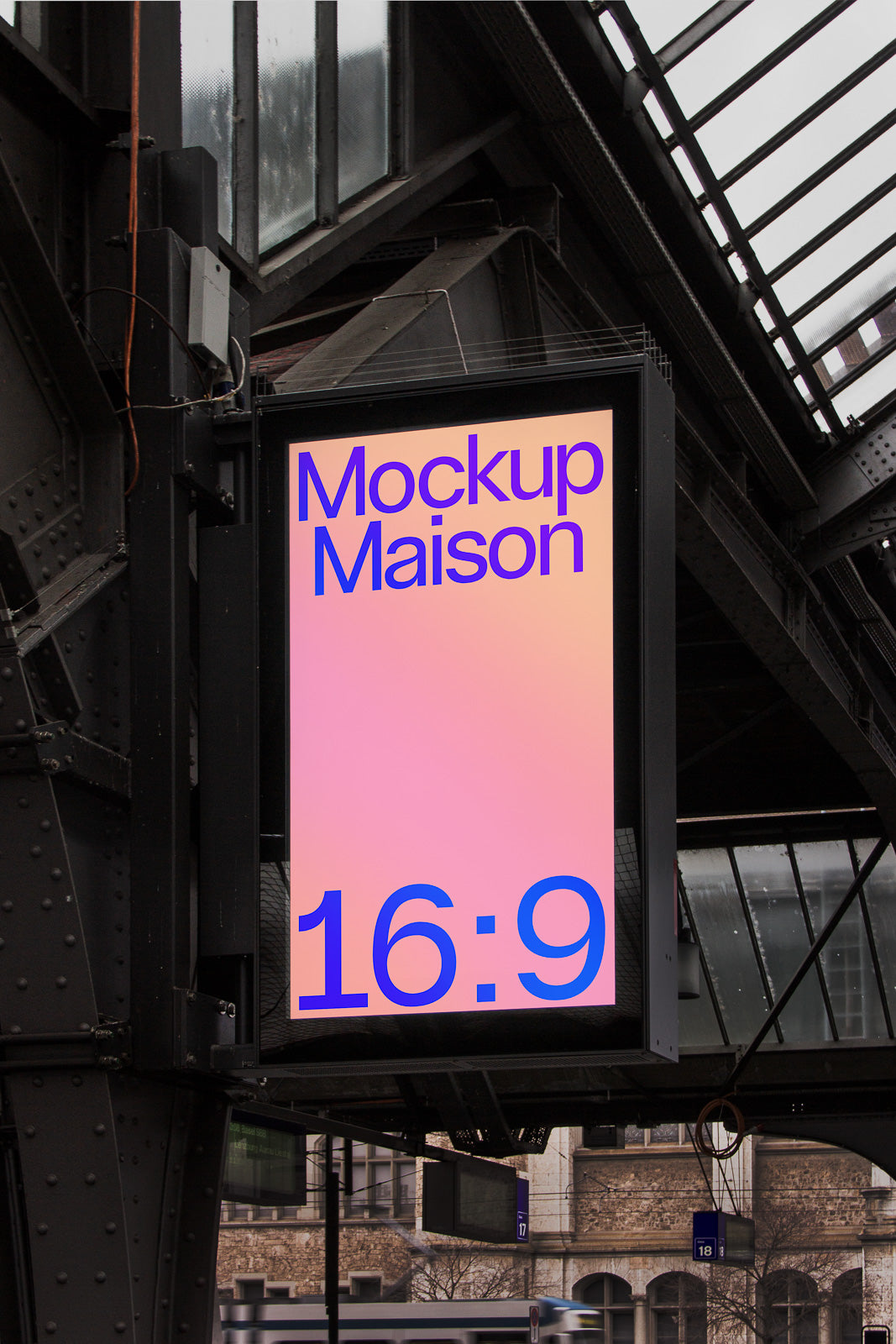 PSD mockup of a digital billboard under a glass roof, displaying "Mockup Maison" and "16:9" in bold blue text against a gradient background.