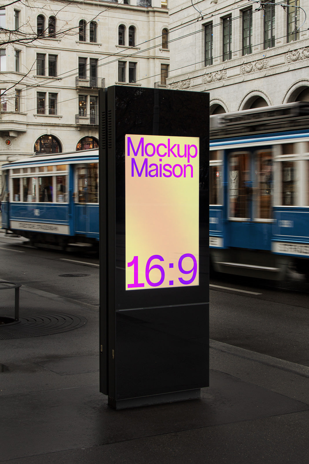 PSD mockup of a street digital billboard displaying text "Mockup Maison 16:9" with a blurred city tram in the background.