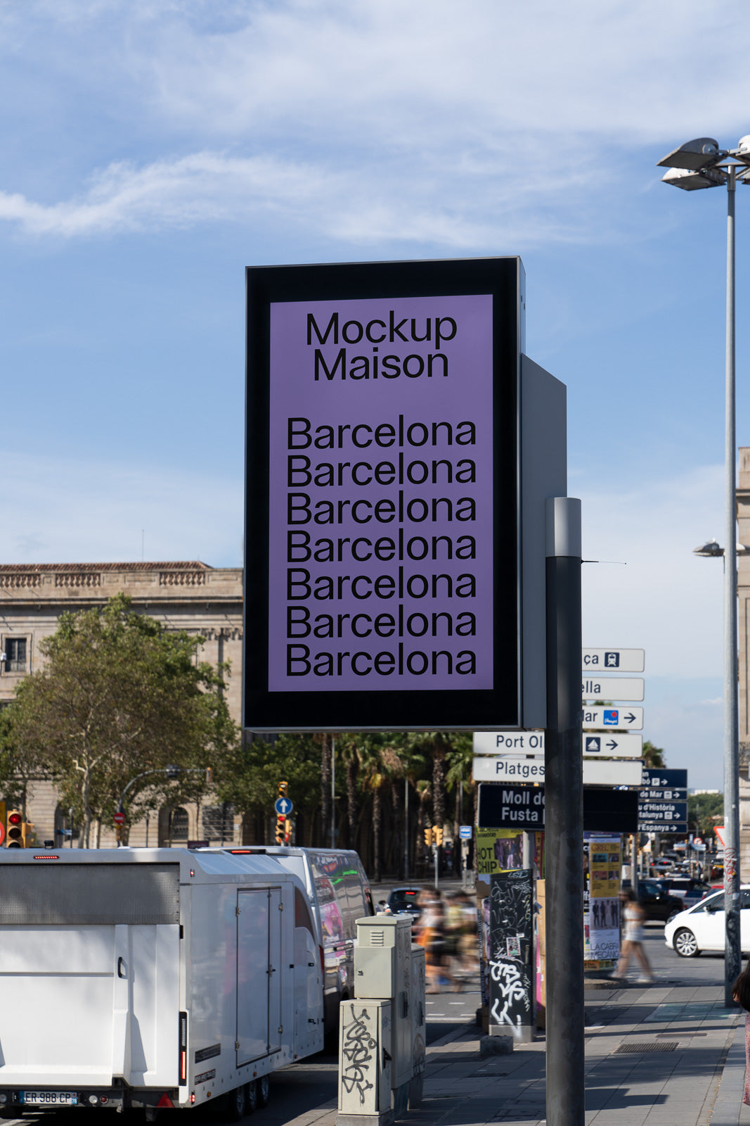 PSD mockup of an outdoor digital sign displaying "Mockup Maison" and repeated "Barcelona" against a city street backdrop with vehicles and trees.