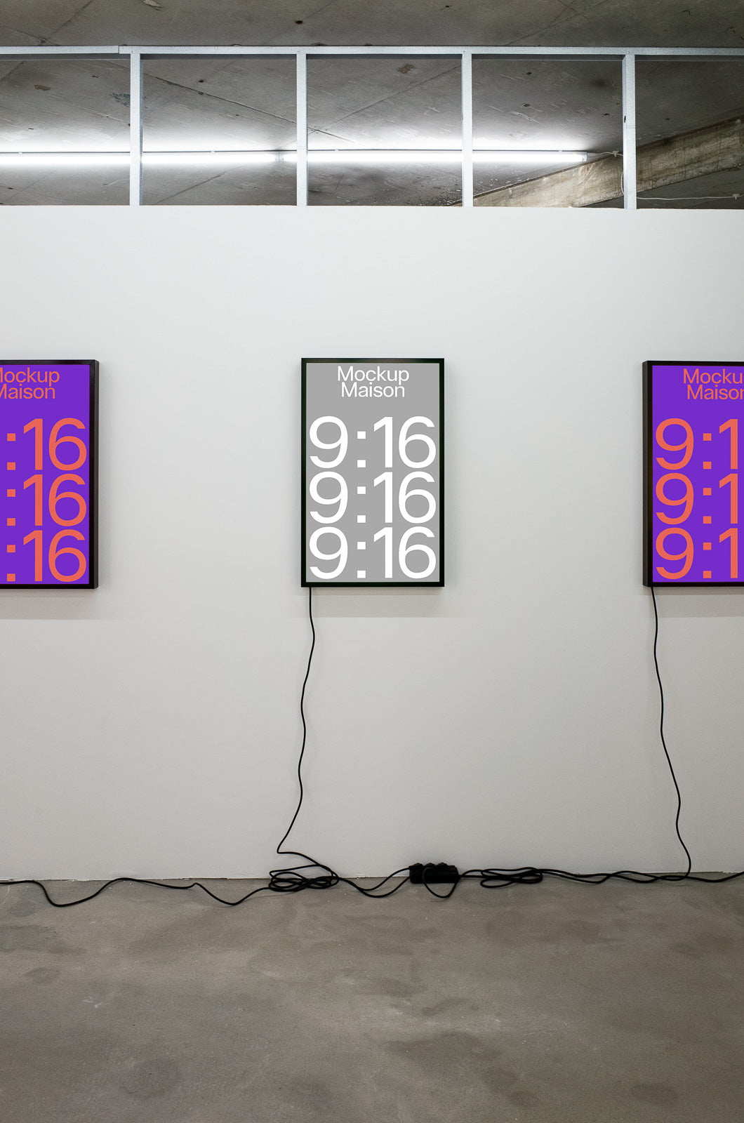 PSD mockup of three vertical posters displayed on a white wall in a minimal room, featuring digital time display design with visible electrical cords.