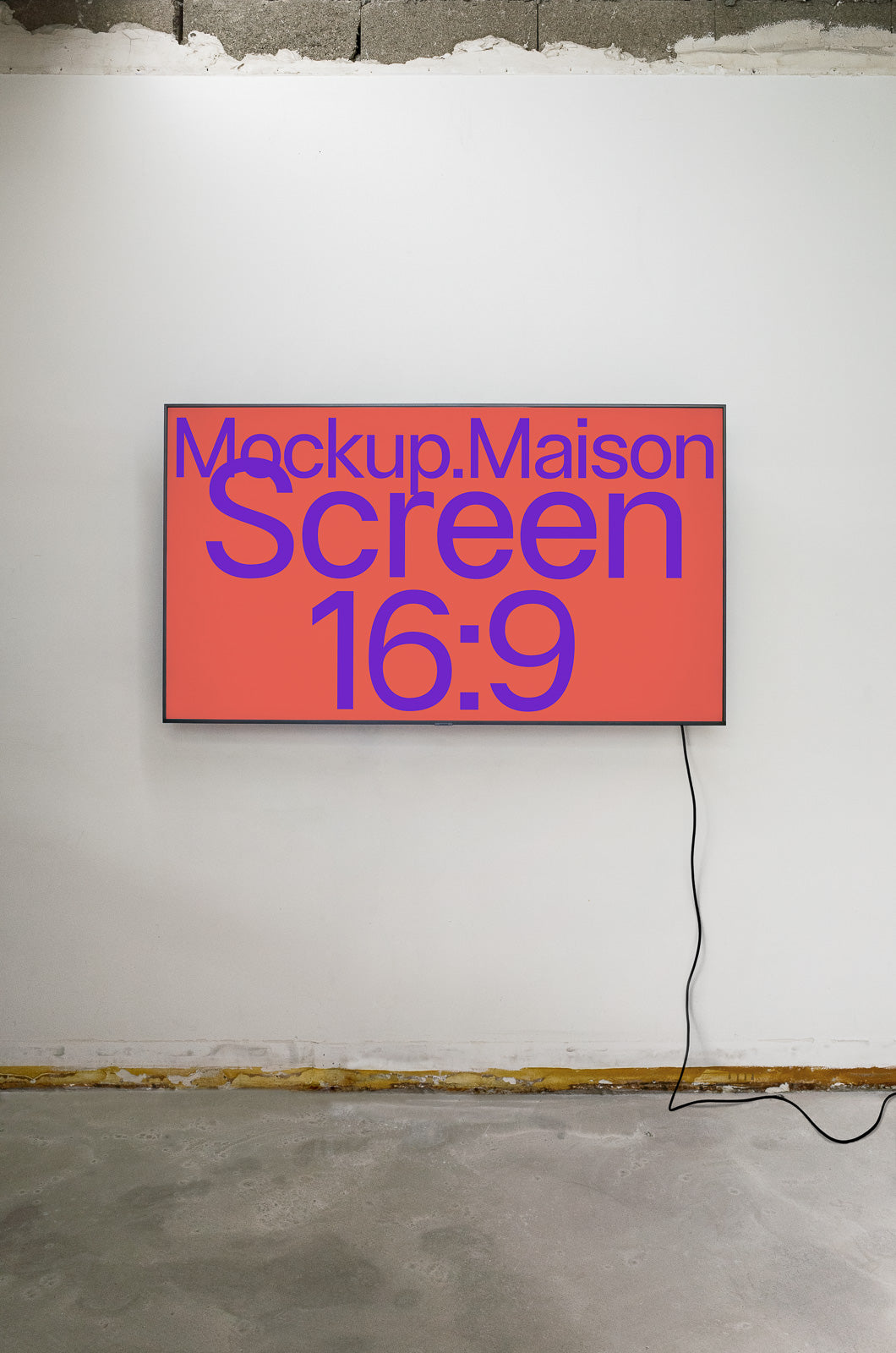 PSD mockup of a wall-mounted screen with a 16:9 aspect ratio, displaying "Mockup.Maison" in purple on a red background, with a visible cord hanging.