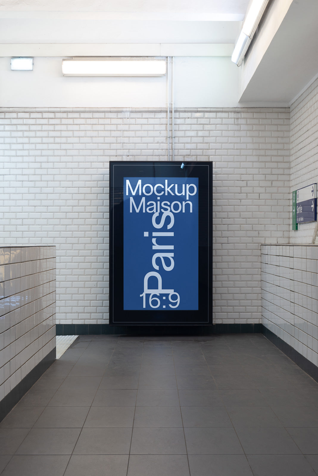 PSD mockup of a digital advertisement display mounted on a subway platform wall, featuring "Mockup Maison Paris 16:9" in blue and white text.