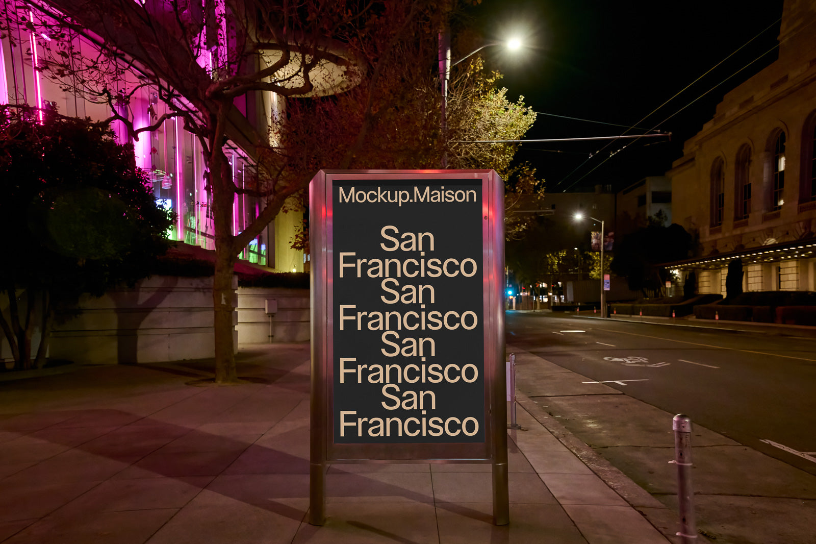 PSD mockup of an illuminated poster stand on an urban street at night, displaying "San Francisco" text in bold under bright city lights.