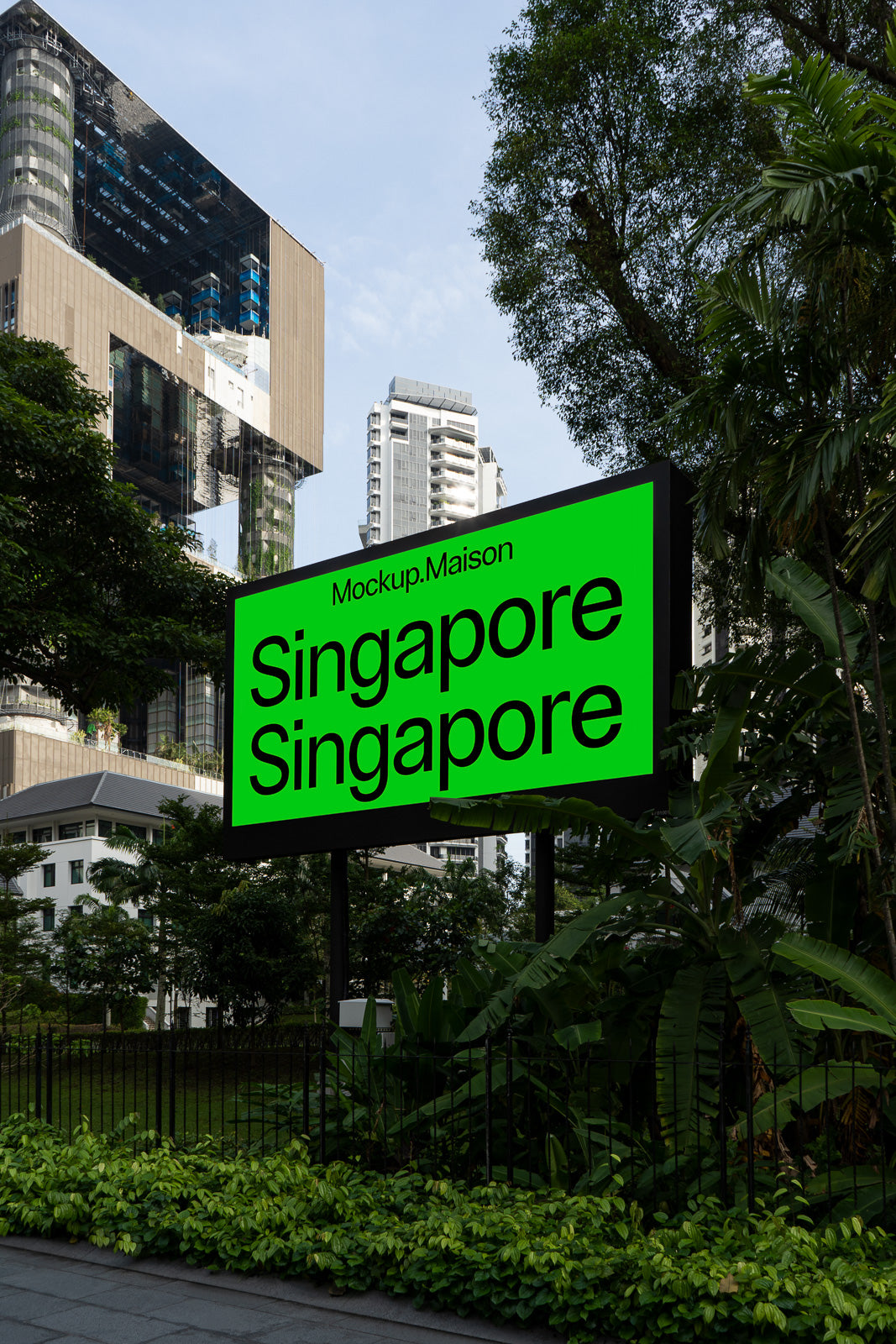 PSD mockup of a bright green outdoor sign in an urban setting with skyscrapers and lush greenery in the background.