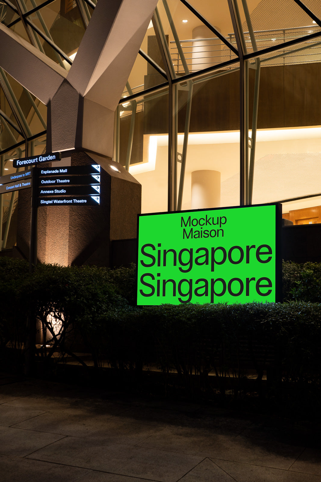 PSD mockup of a bright green sign displaying the words "Mockup Maison Singapore Singapore" in a modern architectural setting at night.