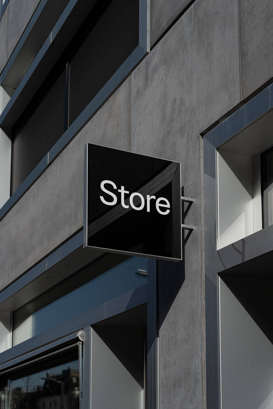 PSD mockup of a modern store sign on a building, featuring a sleek design with the word "Store" in white text on a black background.