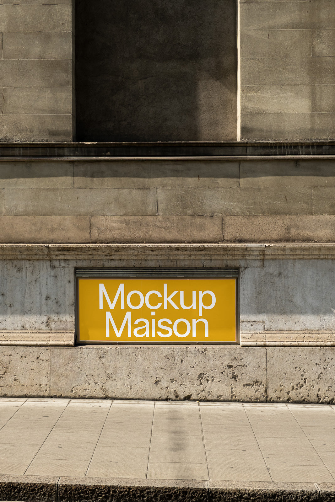 PSD mockup of a yellow storefront sign mounted on a stone building wall, displaying the text "Mockup Maison" in white letters.
