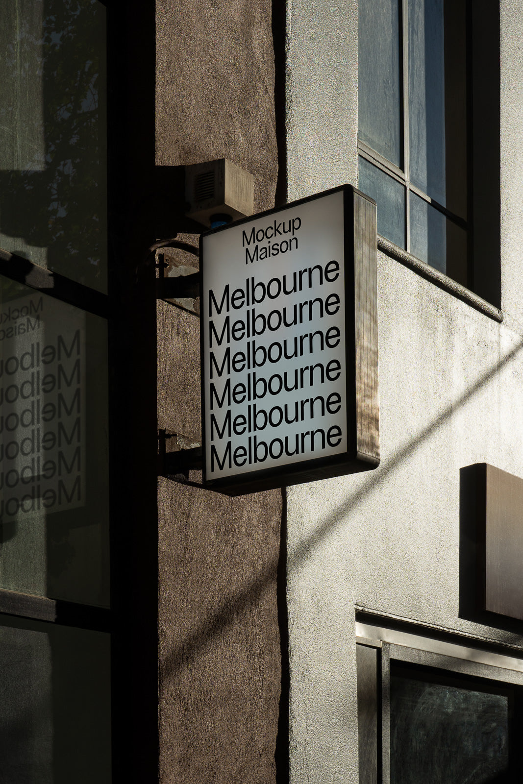 PSD mockup of a vertical rectangular shop sign attached to a building, displaying repeated text "Melbourne" in bold letters.