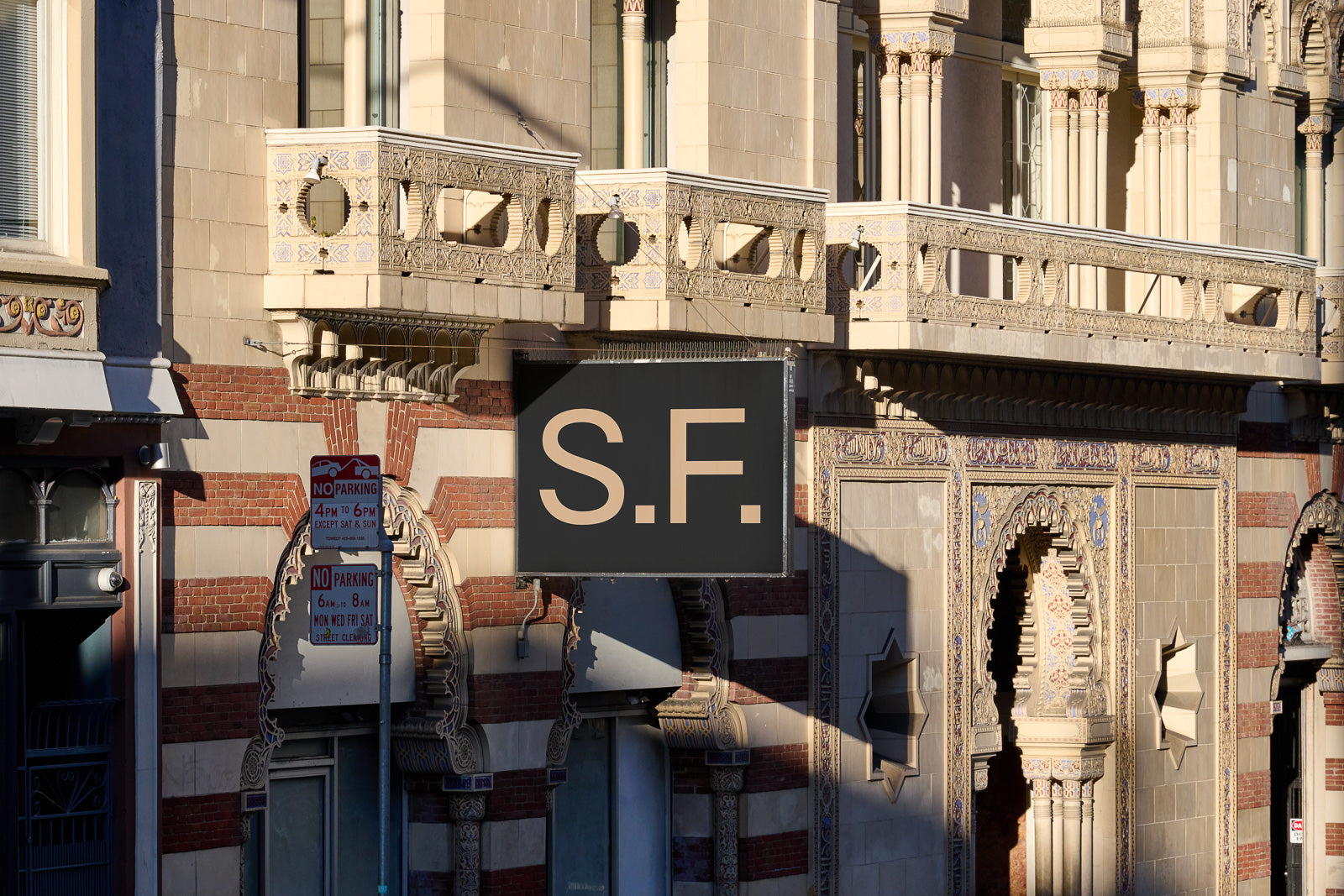 PSD mockup of a building facade featuring intricate architectural details with a sign reading "S.F." in bold letters.
