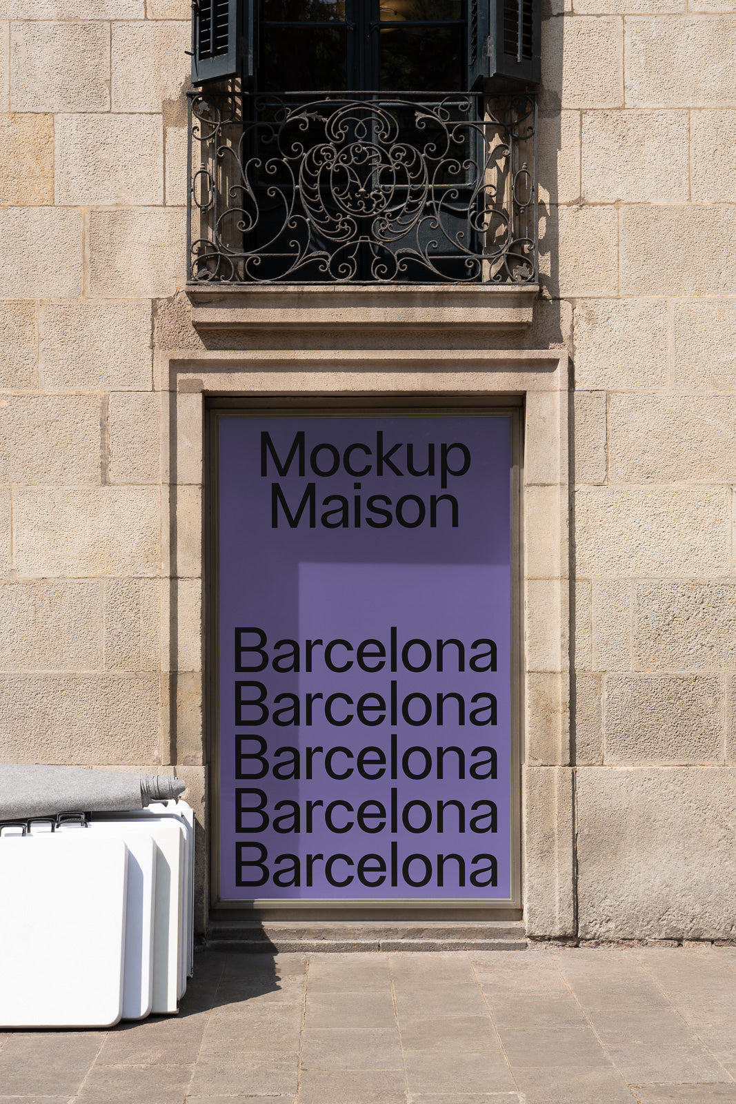 PSD mockup of a storefront with a purple poster displaying the text "Mockup Maison" and "Barcelona" multiple times against a stone wall background.