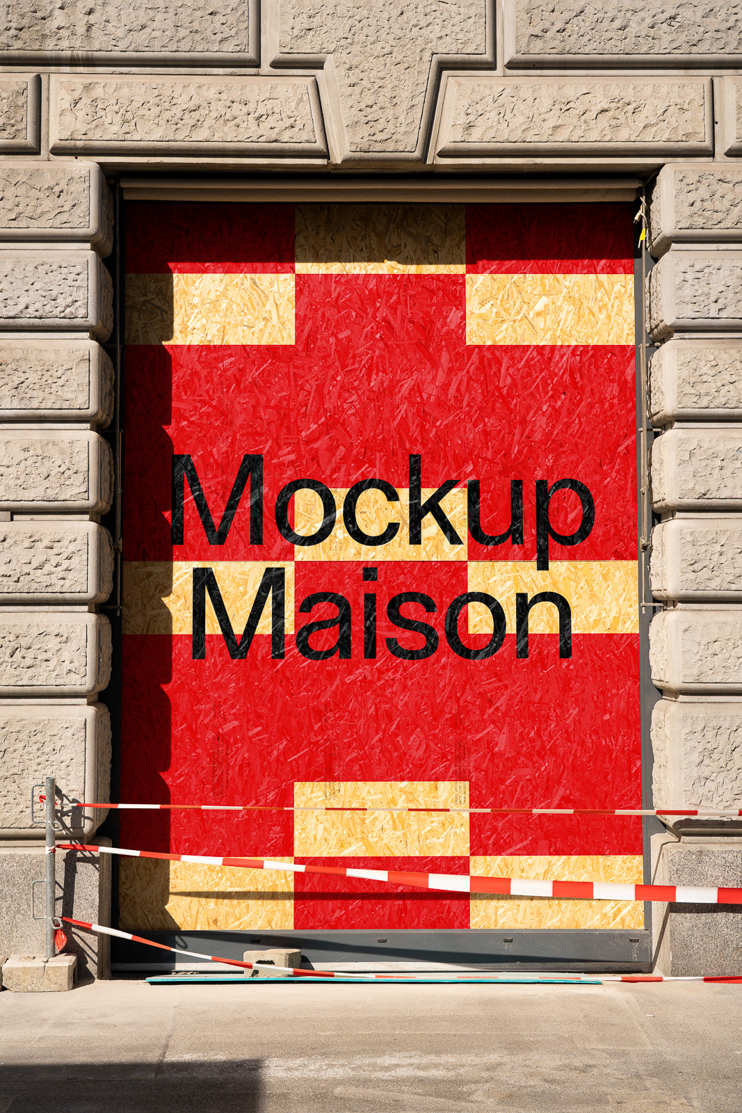 PSD mockup of a large wooden door with a red stencil reading "Mockup Maison" set against a stone facade with surrounding construction barriers.