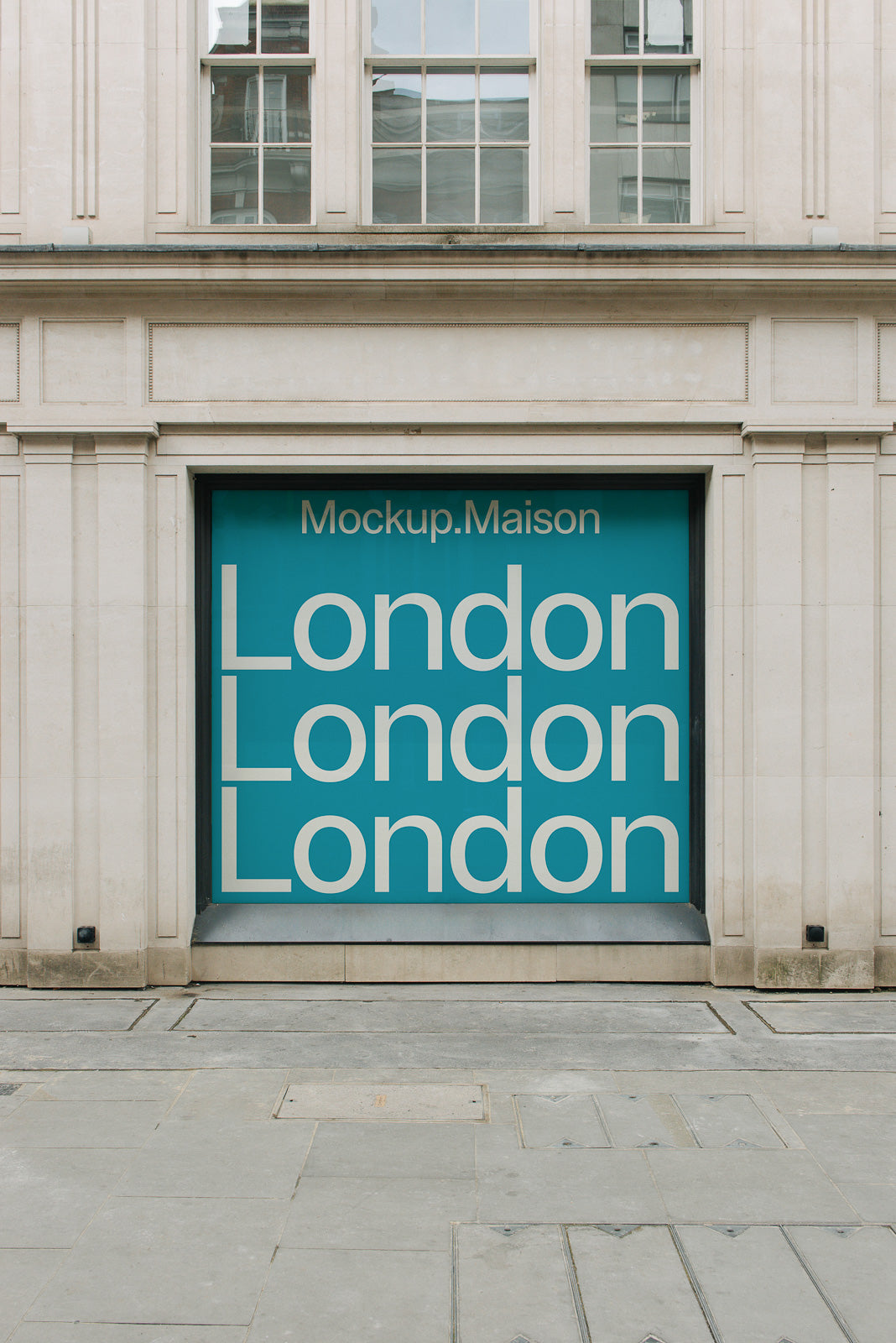 PSD mockup of a storefront showcasing a large display with repeated text "London" on a teal background, framed by a classic building facade.