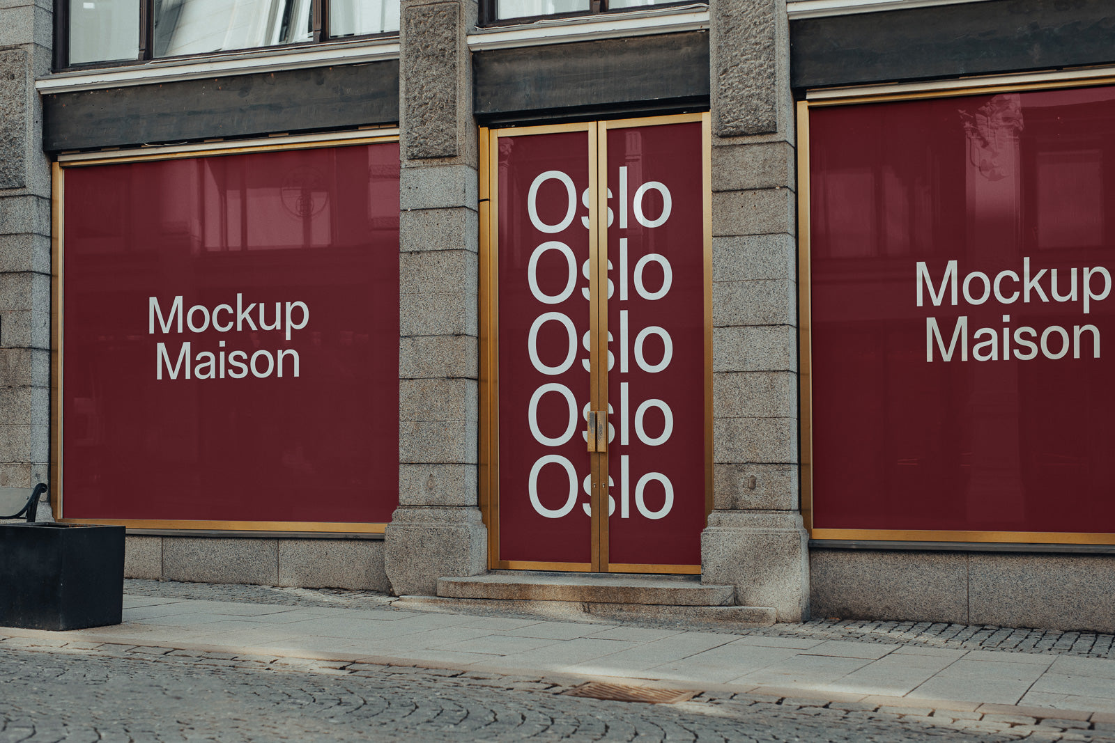 PSD mockup of storefront with red window panels displaying "Mockup Maison" and "Oslo", framed by stone walls and gold accents.