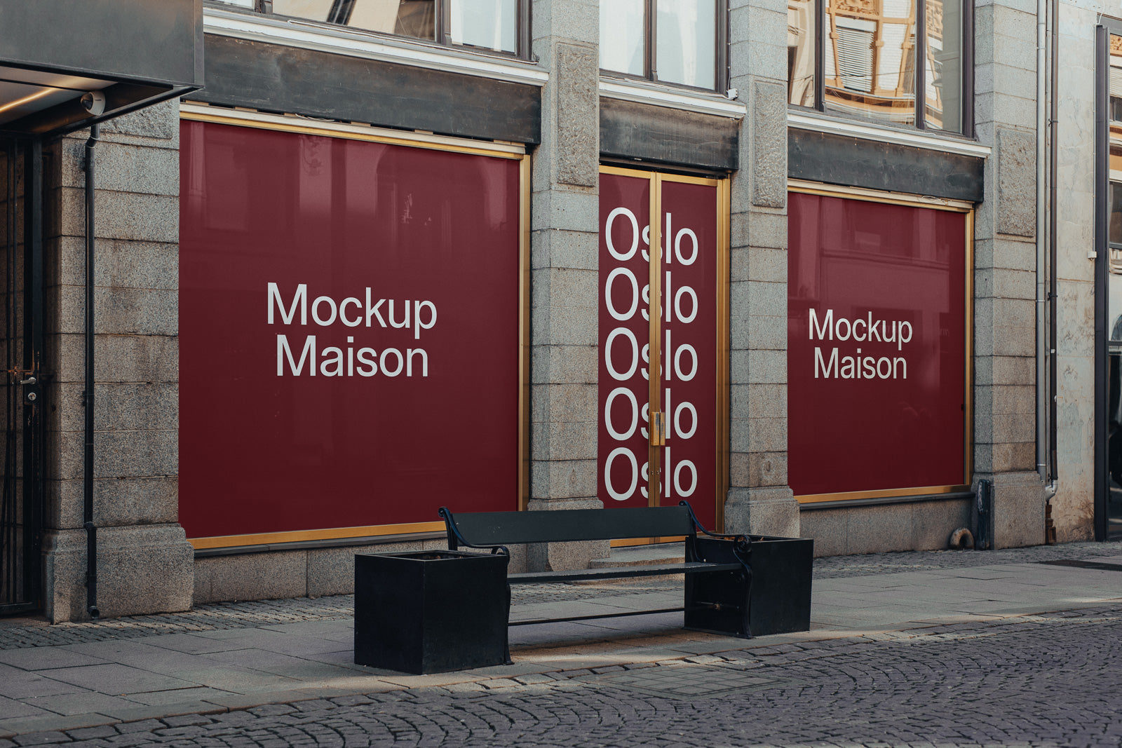 PSD mockup of storefront with large red banners saying "Mockup Maison" and "Oslo," set in an urban street scene with a bench.