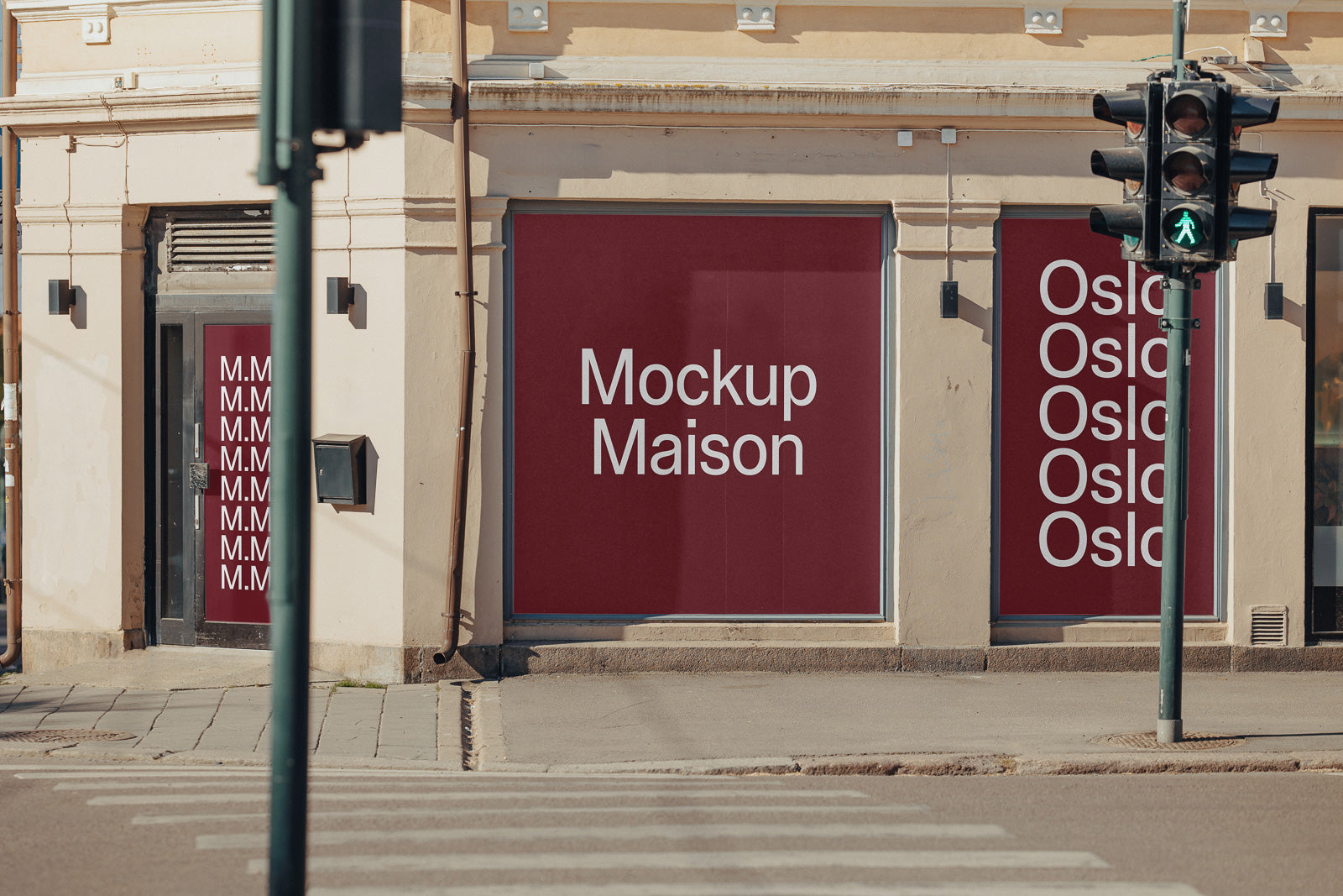 PSD mockup of a building facade displaying red panels with white text reading "Mockup Maison" and "Oslo," near a pedestrian crossing and traffic light.