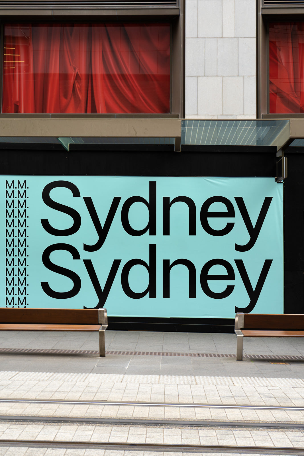PSD mockup of a building facade displaying bold black text "Sydney" on a turquoise background, with a row of red draped windows above.