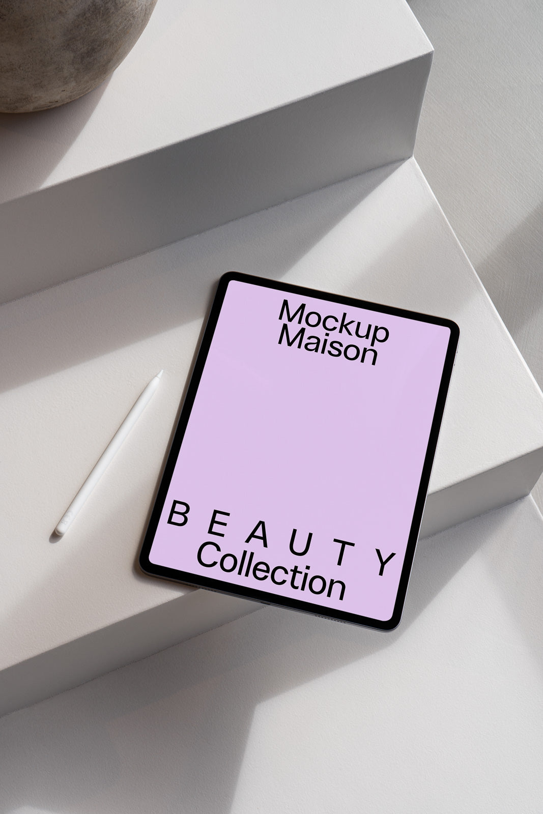 PSD mockup of a tablet on white steps with a stylus, featuring text "Mockup Maison" and "BEAUTY Collection" on a lavender screen.