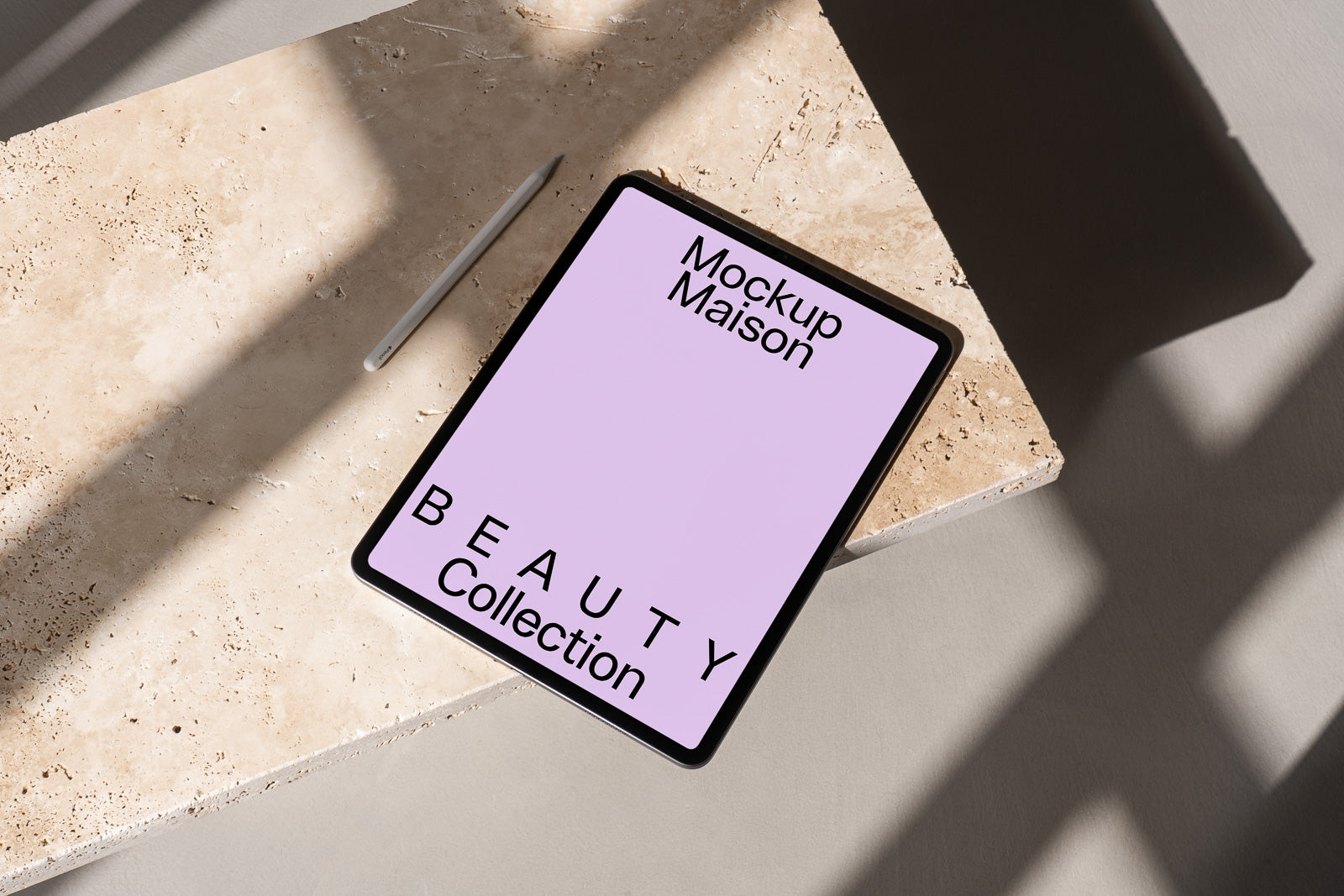 PSD mockup of an iPad on a marble surface with a stylus nearby, displaying "Mockup Maison: BEAUTY Collection" on its screen in bold text.