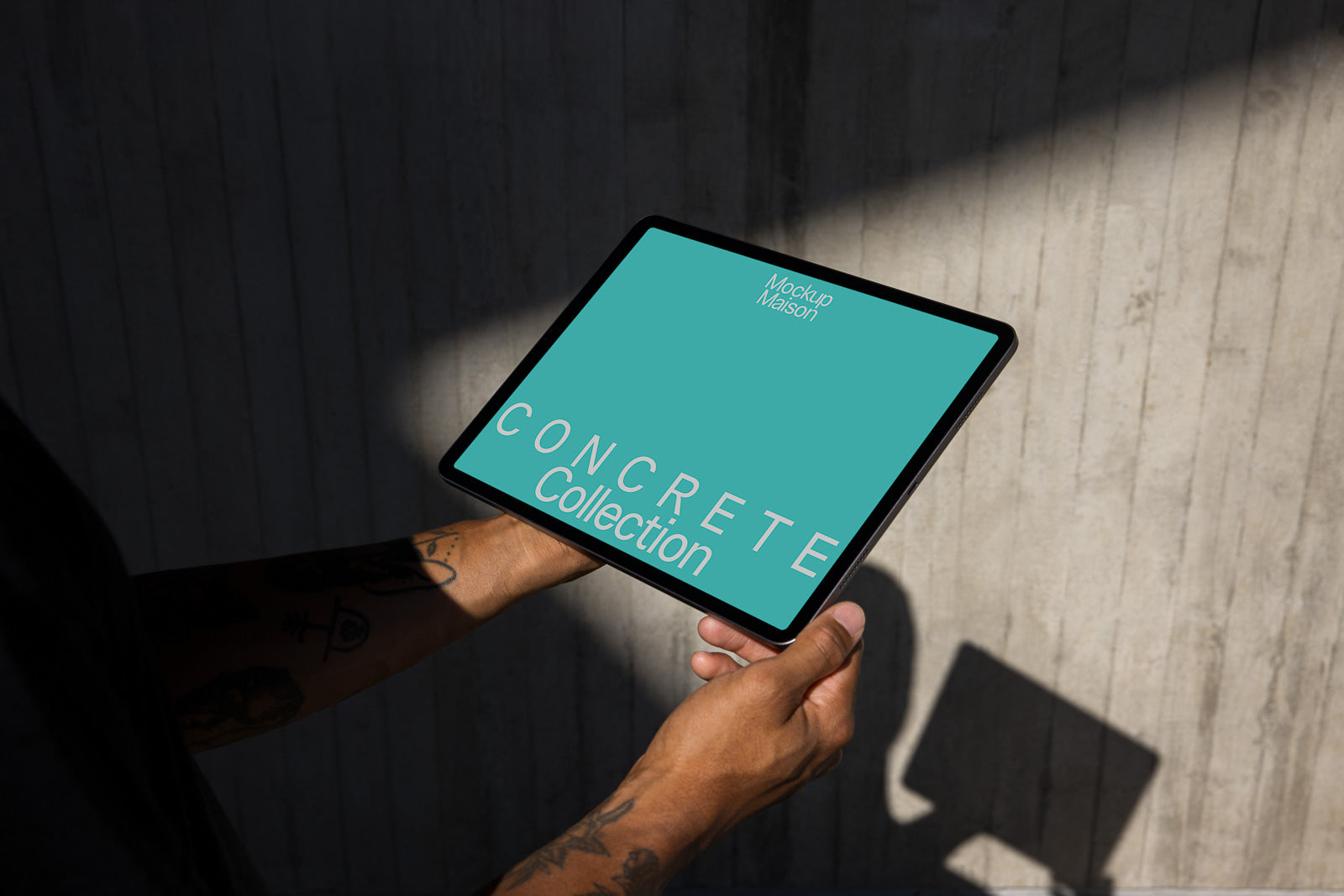 PSD mockup of hands holding a tablet displaying the text "Concrete Collection" against a teal background, with "Mockup Maison" at the top.