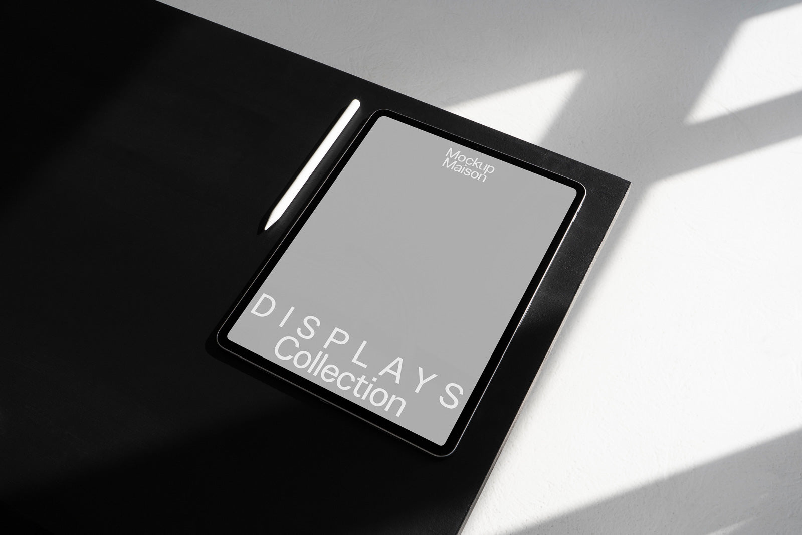 PSD mockup of a digital tablet on a dark surface with an accompanying stylus, displaying "Mockup Maison Displays Collection" on the screen.