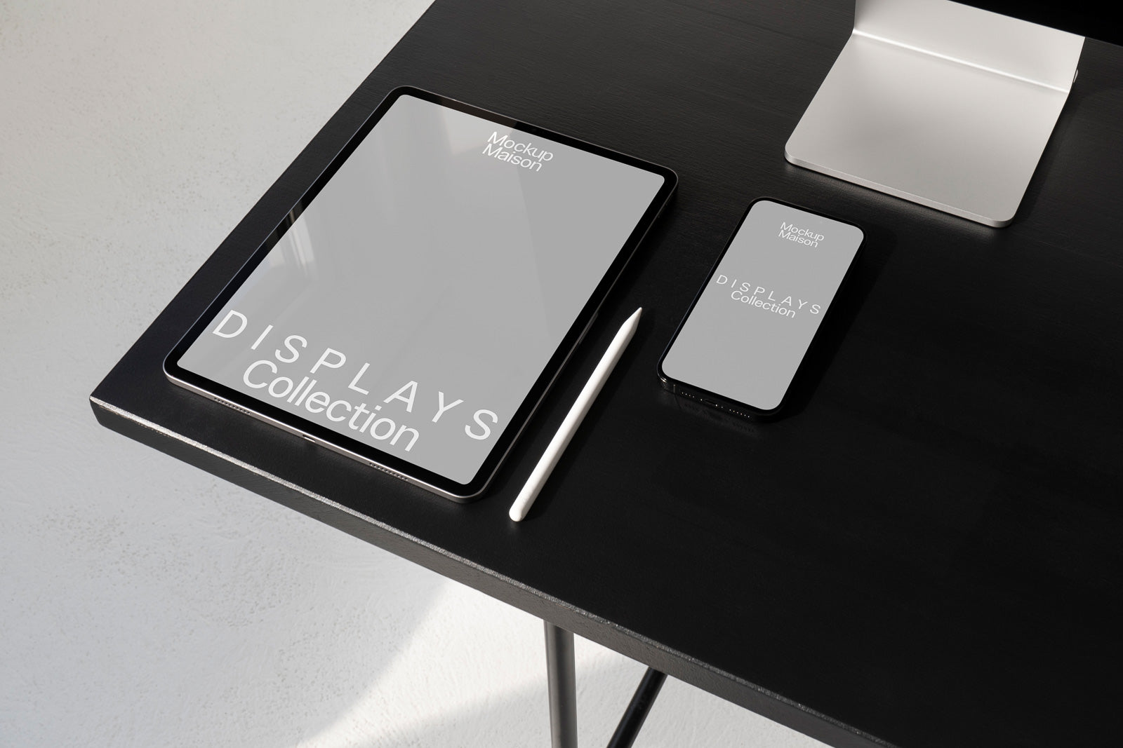 PSD mockup of a digital display set featuring a tablet, smartphone, and stylus on a black desk surface with a minimalist aesthetic.