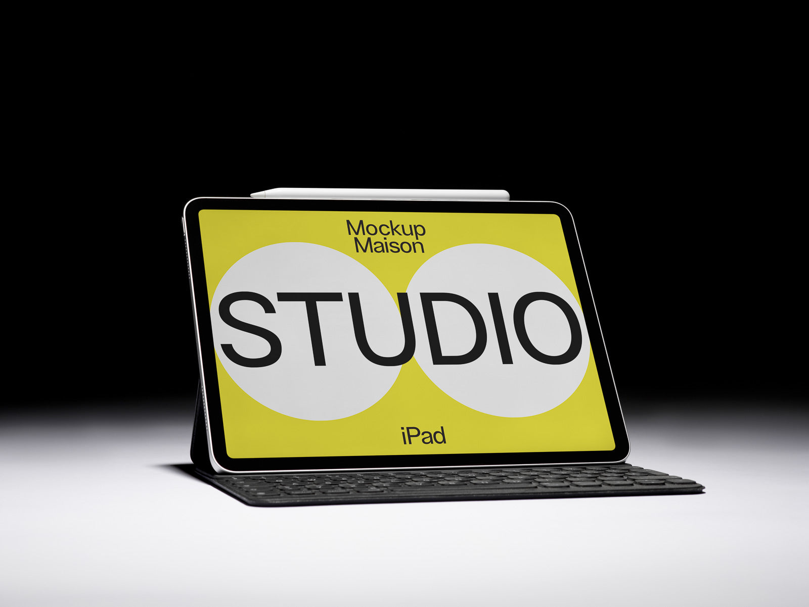 PSD mockup of an iPad with a keyboard displaying a design titled "Mockup Maison STUDIO" against a bright yellow background with bold black text.