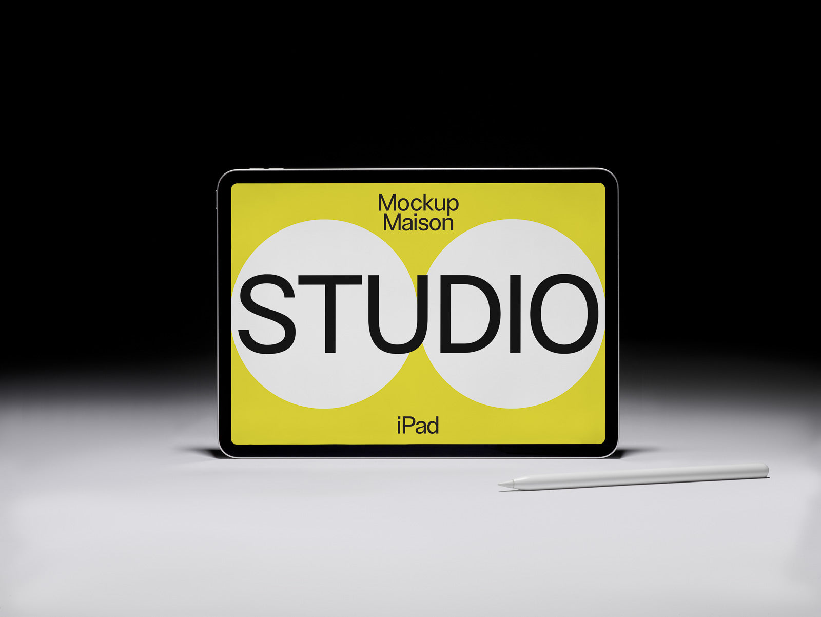 PSD mockup displaying an iPad with a yellow screen featuring the word "STUDIO" in bold letters, accompanied by a stylus on a gradient background.