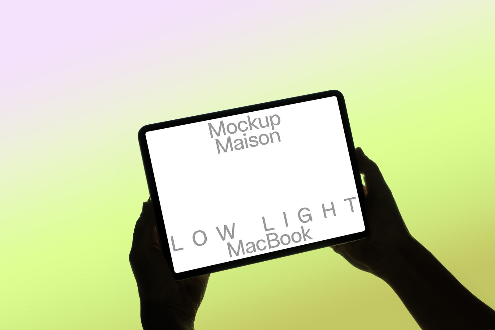PSD mockup of hands holding tablet with "Mockup Maison" display against gradient background. Text on screen reads "LOW LIGHT MacBook."