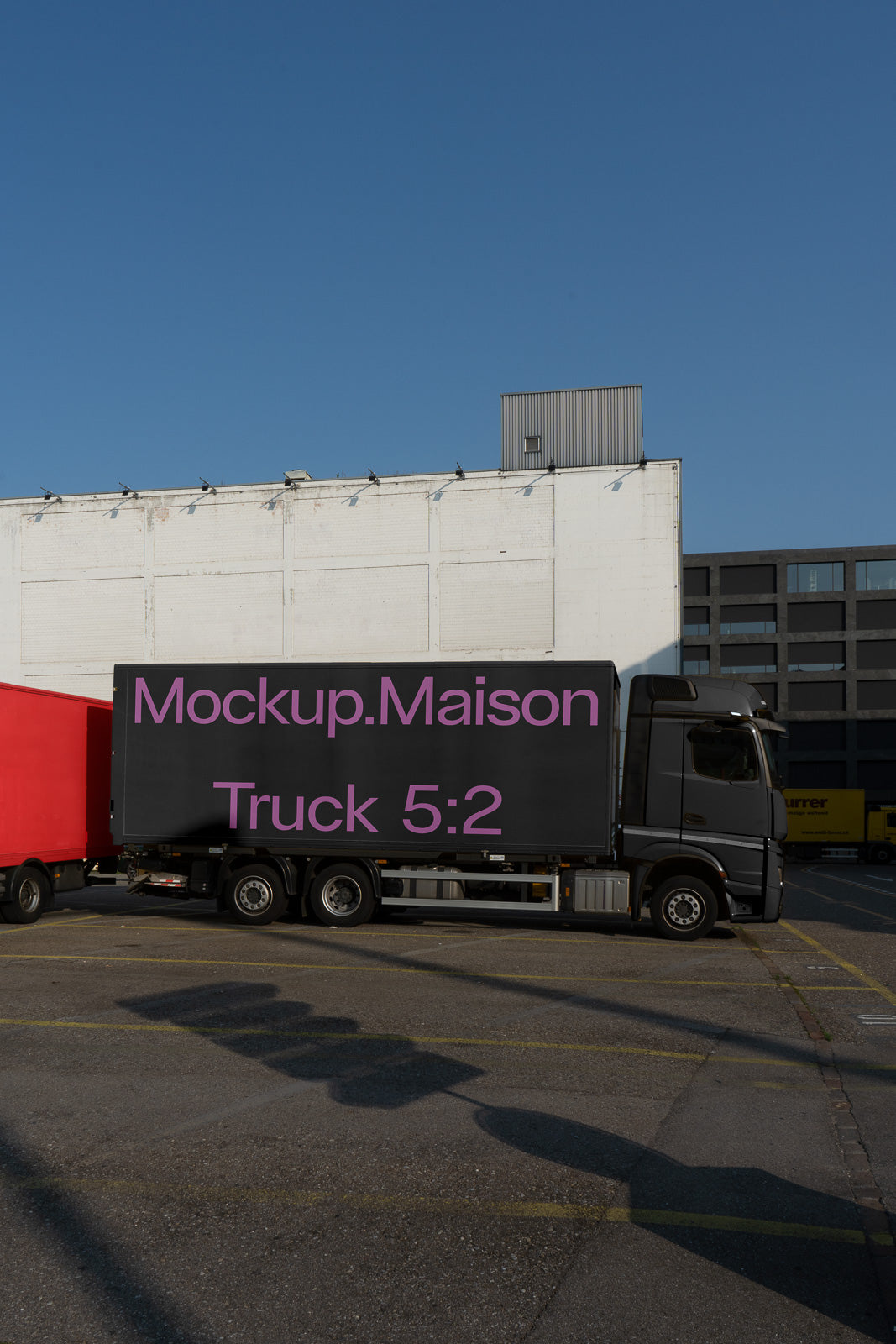 PSD mockup of a truck trailer displaying "Mockup.Maison Truck 5:2" in large pink text against a black background.