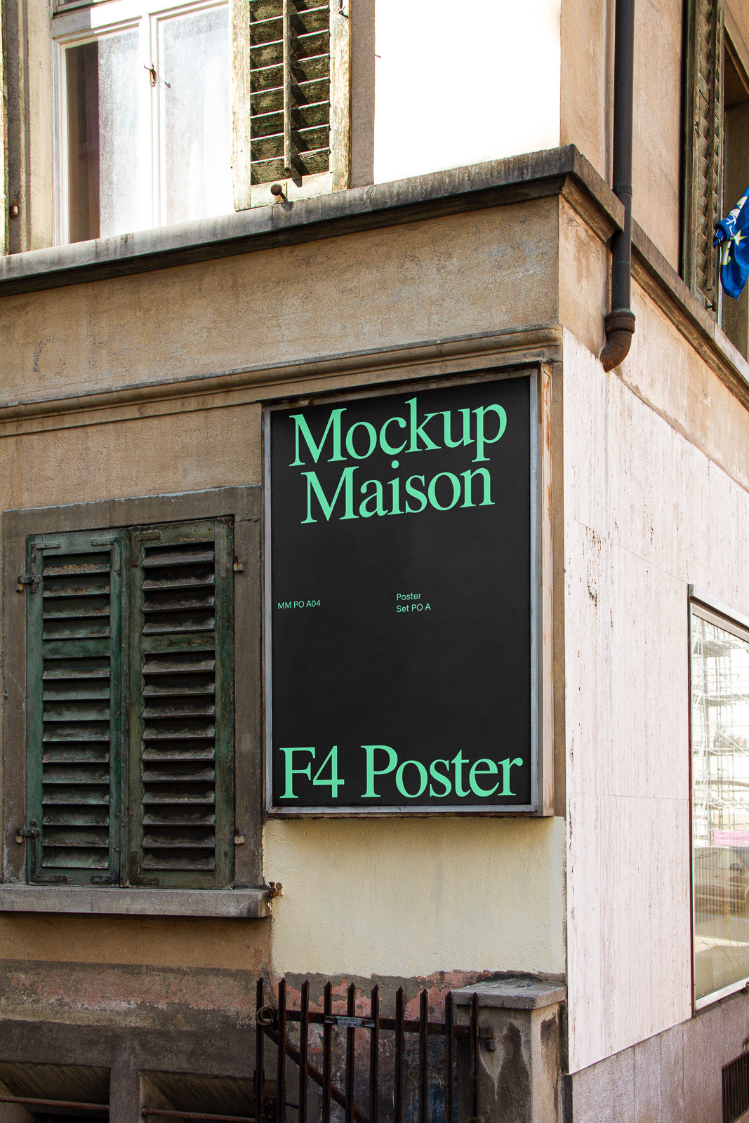 PSD mockup of a black F4 poster mounted on the corner of a rustic building, next to a shuttered window, showcasing "Mockup Maison" in green text.
