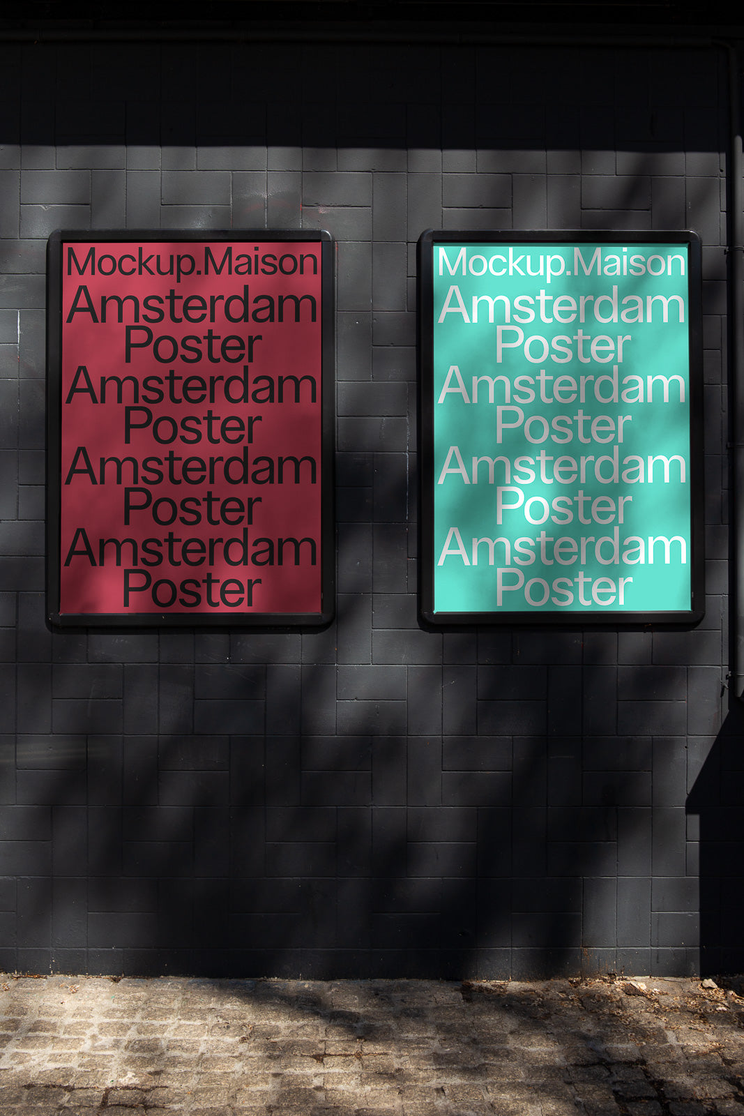 PSD mockup of two posters on a dark tiled wall under dappled sunlight; one poster is red with bold black text, the other is teal with white text.