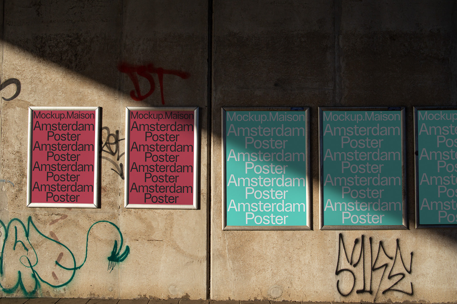 PSD mockup of four framed posters mounted on a concrete wall with graffiti, displaying "Mockup.Maison Amsterdam Poster" in bold text.