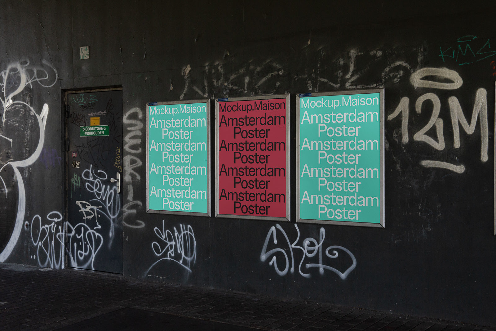 PSD mockup of three posters displayed on a graffiti-covered wall, featuring the text "Mockup. Maison Amsterdam Poster" in different colors.