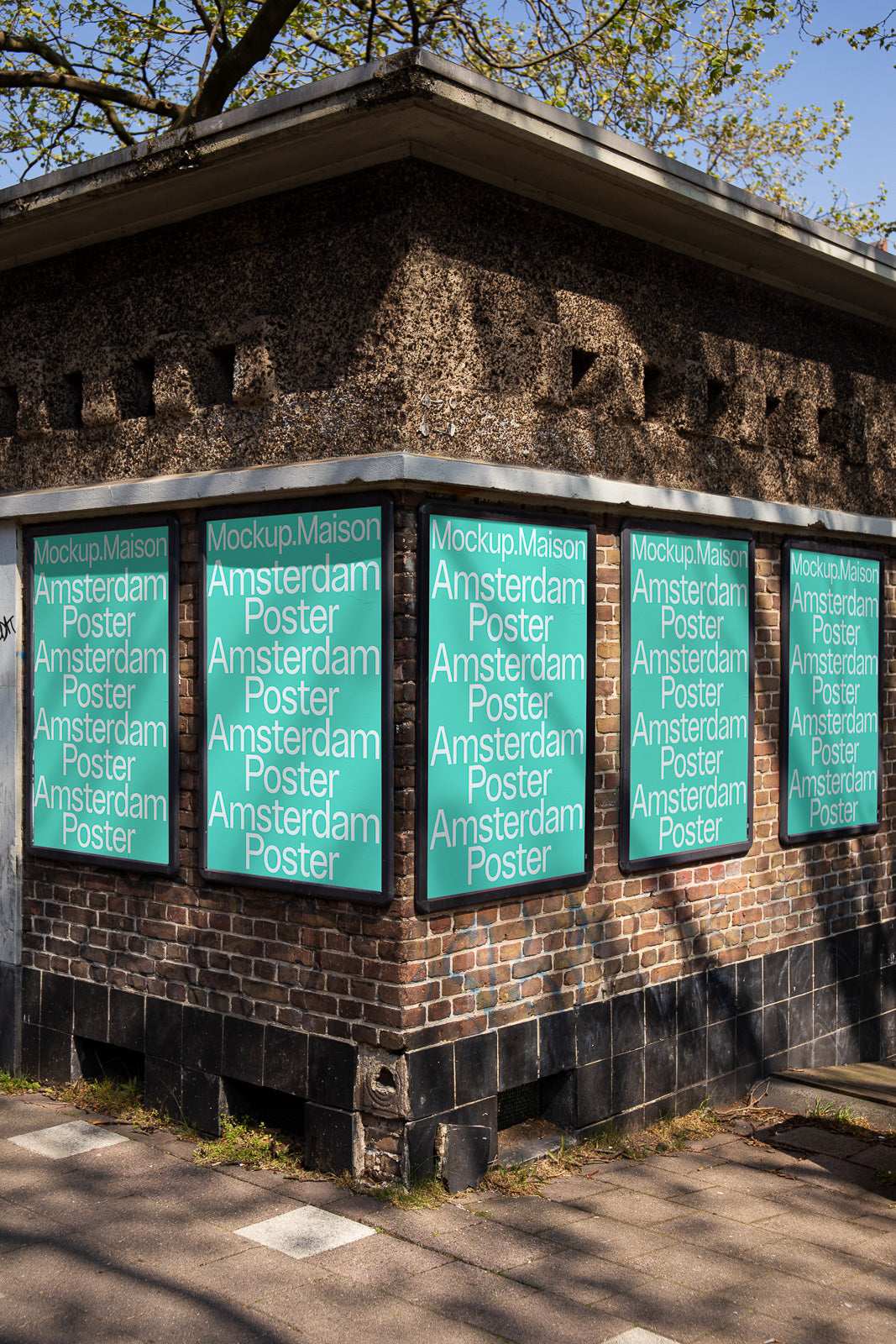 PSD mockup of multiple posters on a brick wall corner, each displaying the text "Amsterdam Poster."