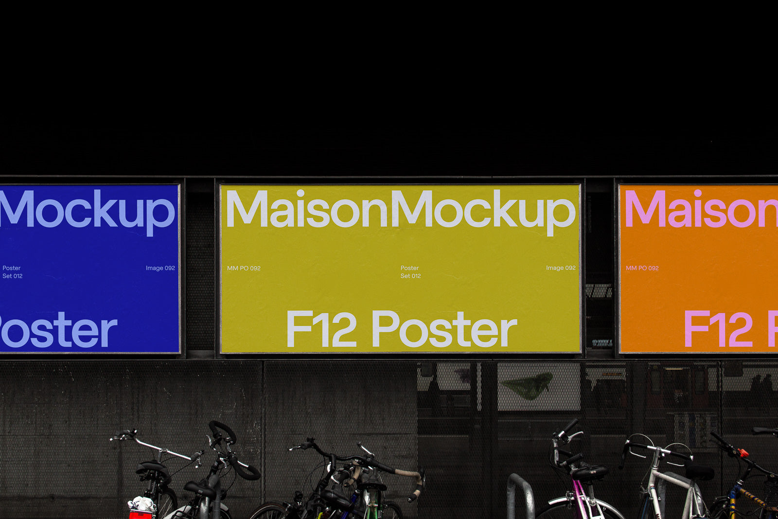 PSD mockup of urban billboard posters in blue, yellow, and orange, displaying "MaisonMockup" text, with bicycles parked below against a dark background.