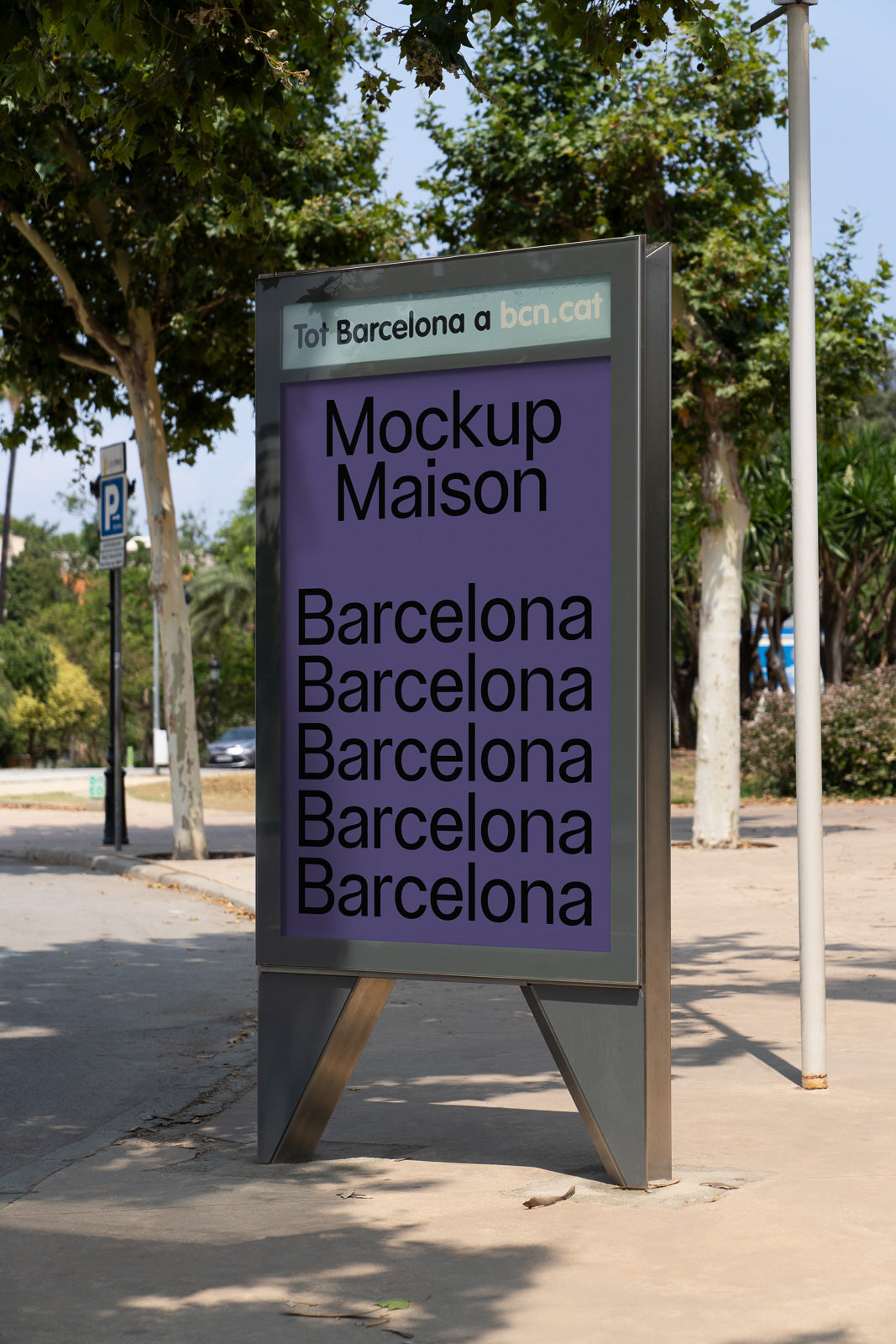 PSD mockup of a metal-framed outdoor sign featuring repeated text "Barcelona" in bold black font on a purple background, set in a park environment.